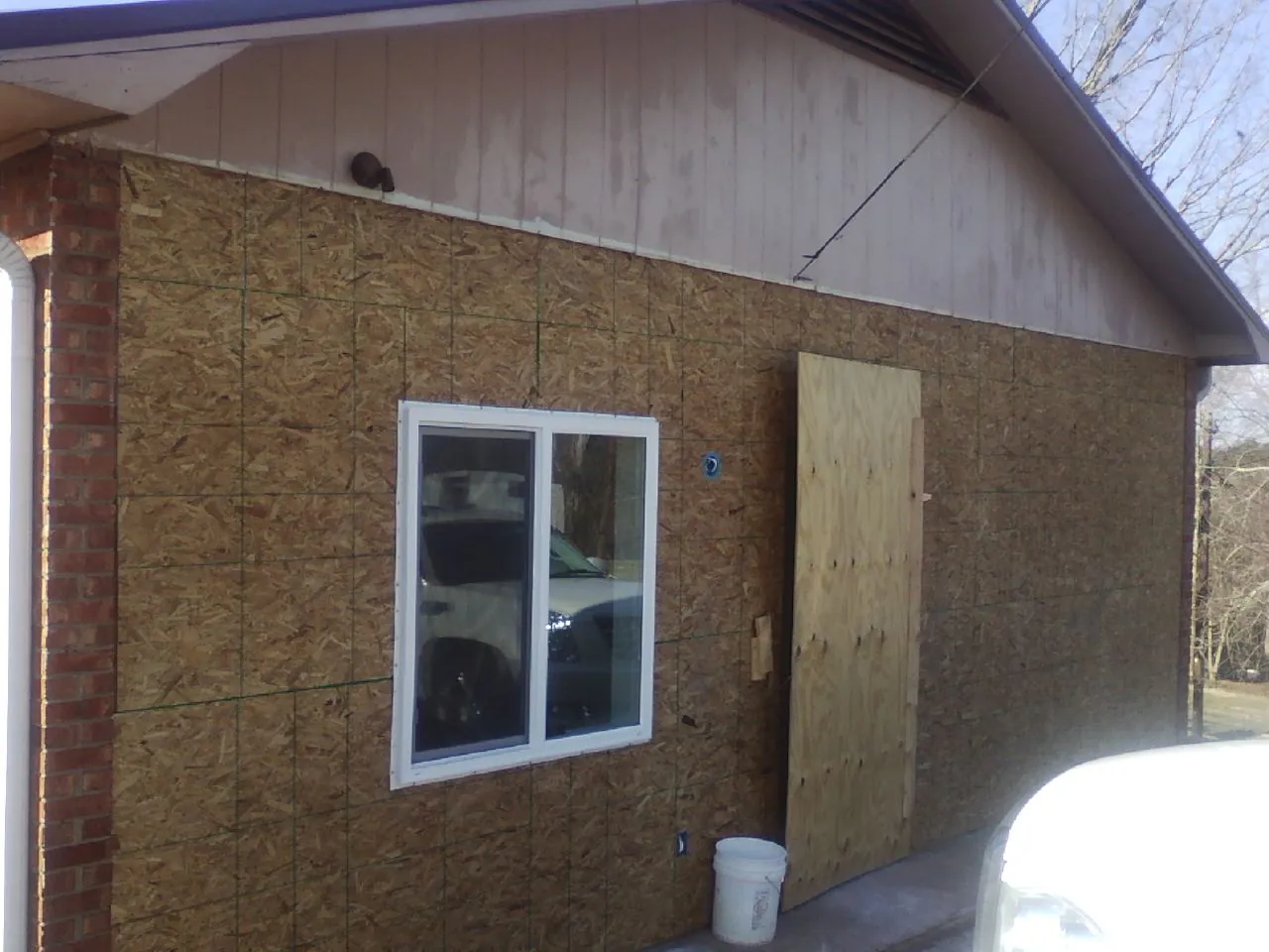 OSB sheathing on a garage addition wall before siding in Guysville