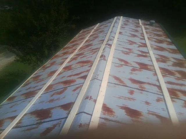 Rusted metal roof panels with new wood purlins before replacement — Storm Damage Roof Repair in Guysville by Roofing Brothers